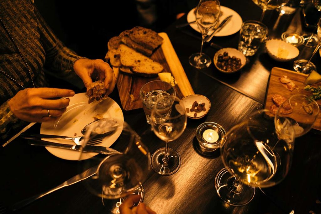 table with wine glasses, champagne tulips and sourdough bread platters.